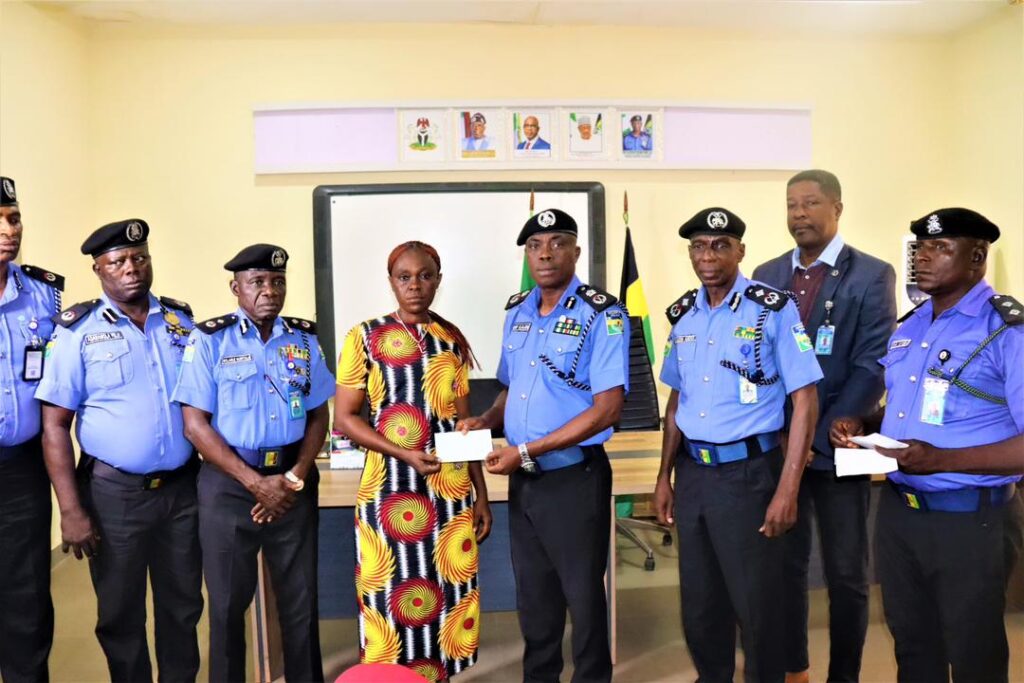 Ogun State Police Commissioner Cp Bode Ojajuni Presenting Cheque To A Family Member Of One Of The Fallen Officers In The Command