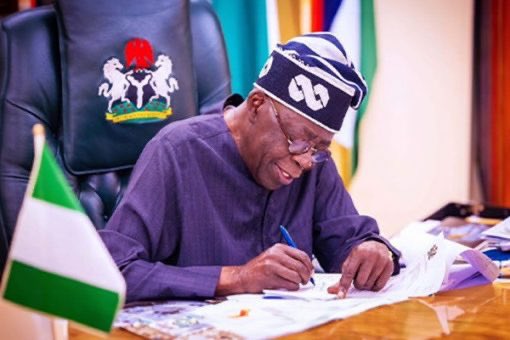 Tinubu Signs Writes
